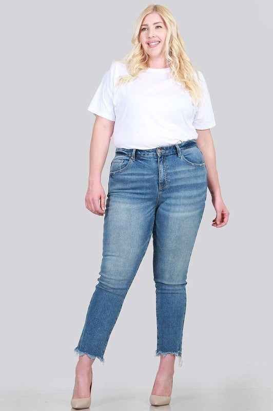 A pair of plus size relaxed skinny jeans featuring a high rise, zipper fly, ankle length with raw cut hem, and five pocket styling.