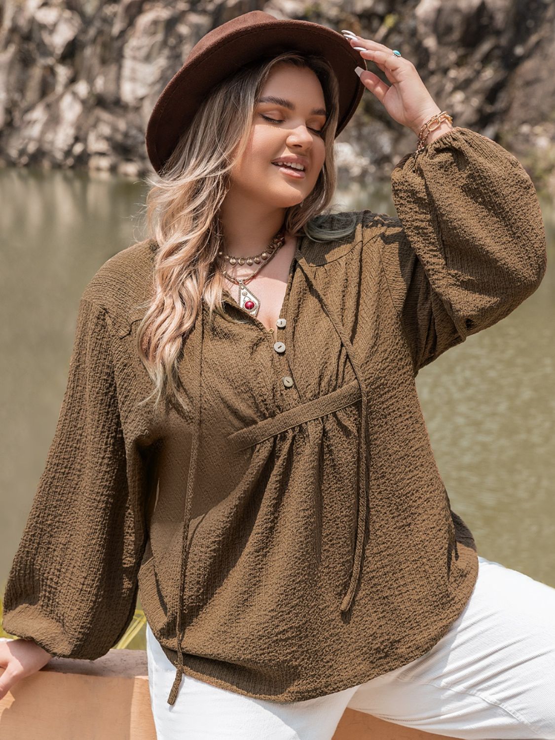 A stylish plus size tie neck long sleeve blouse in a soft fabric, featuring a buttoned front and elegant design, perfect for various occasions.