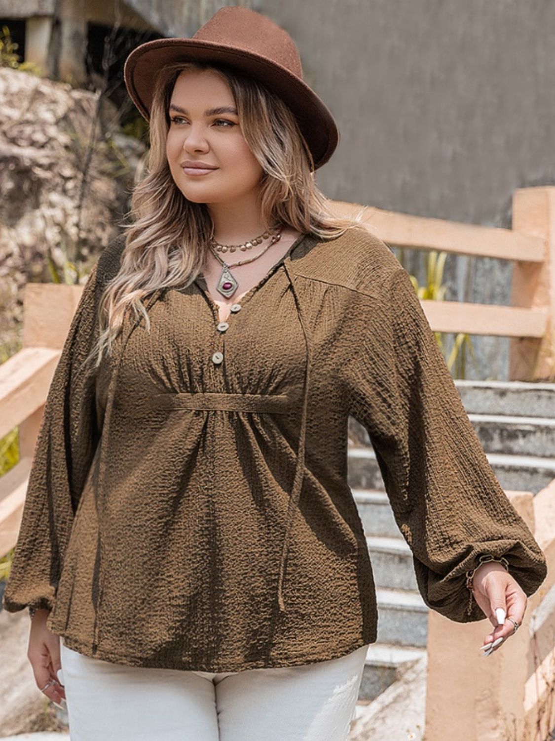 A stylish plus size tie neck long sleeve blouse in a soft fabric, featuring a buttoned front and elegant design, perfect for various occasions.