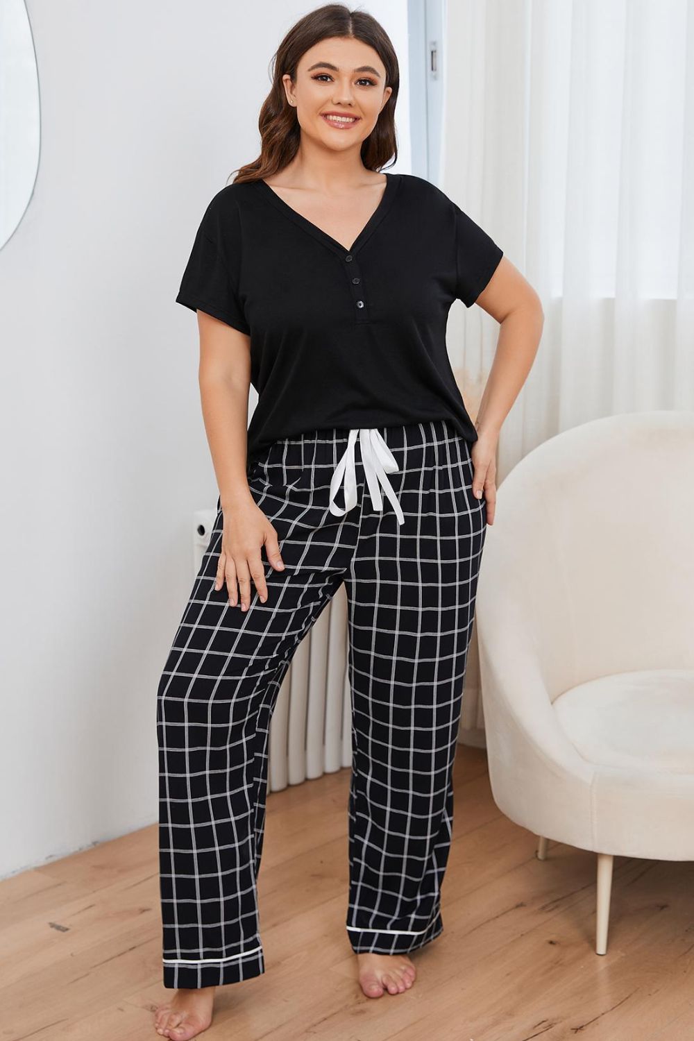 A stylish plus size lounge set featuring a V-neck top and plaid pants, perfect for comfort and casual outings.