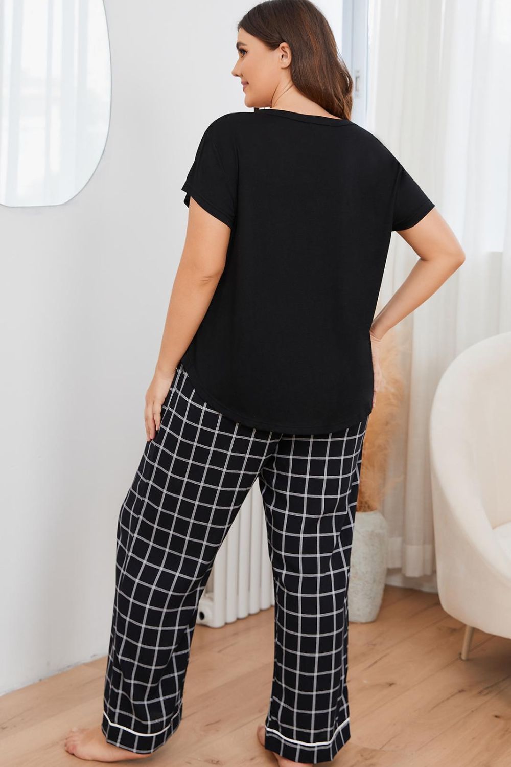 A stylish plus size lounge set featuring a V-neck top and plaid pants, perfect for comfort and casual outings.