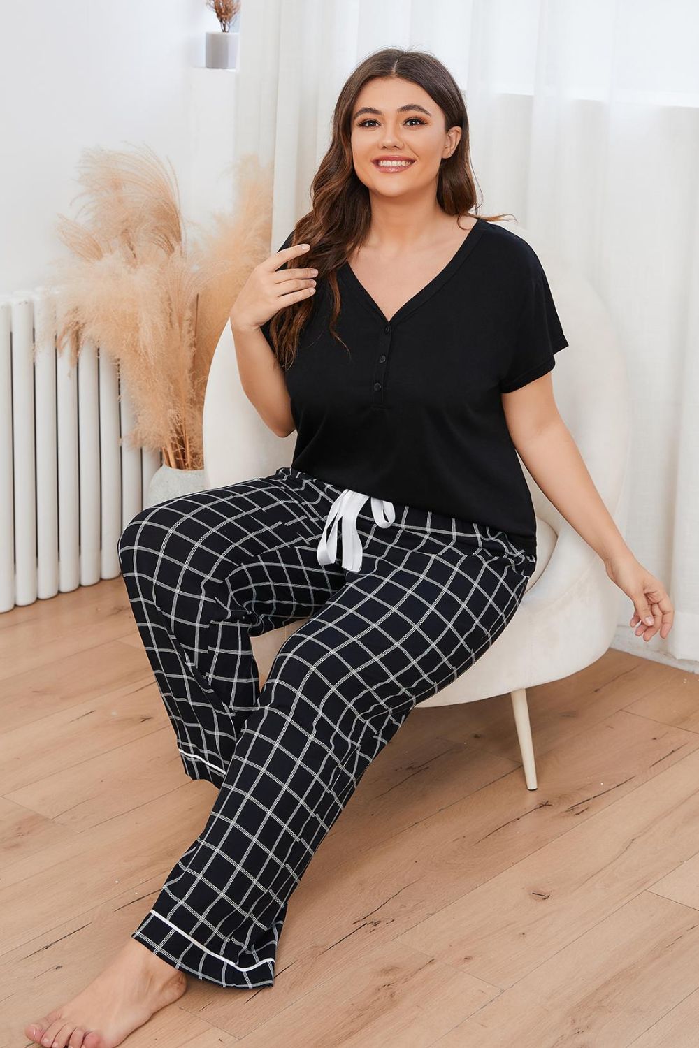 A stylish plus size lounge set featuring a V-neck top and plaid pants, perfect for comfort and casual outings.