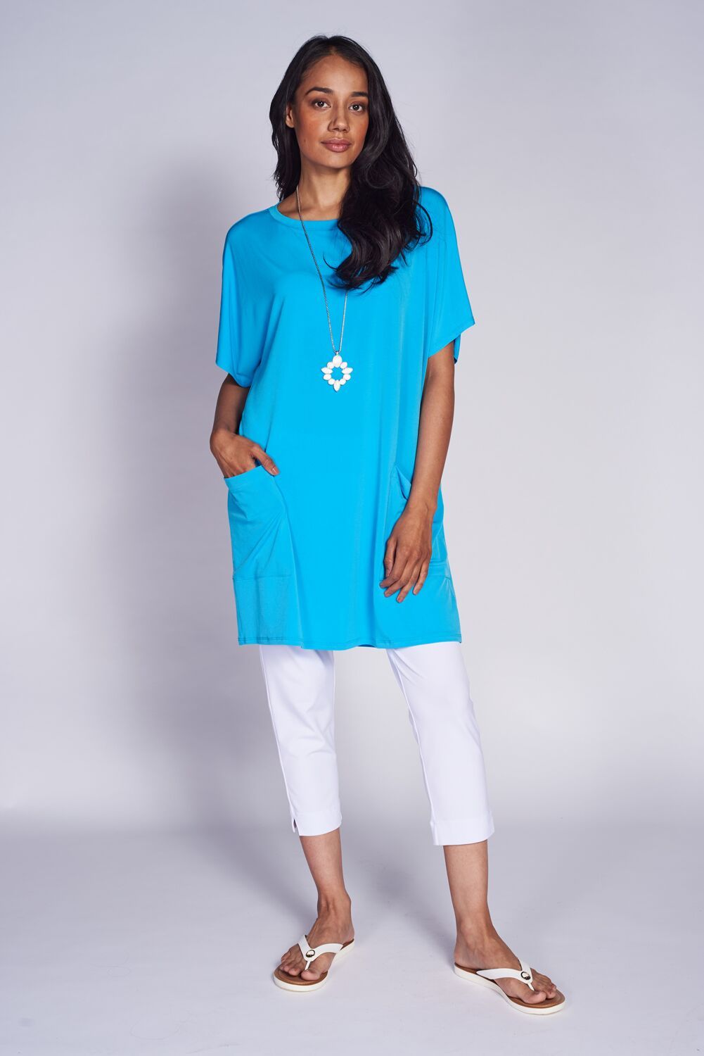 A stylish Pocket Shift Dress featuring a relaxed fit, front pockets, and a scoop neck, perfect for casual wear.