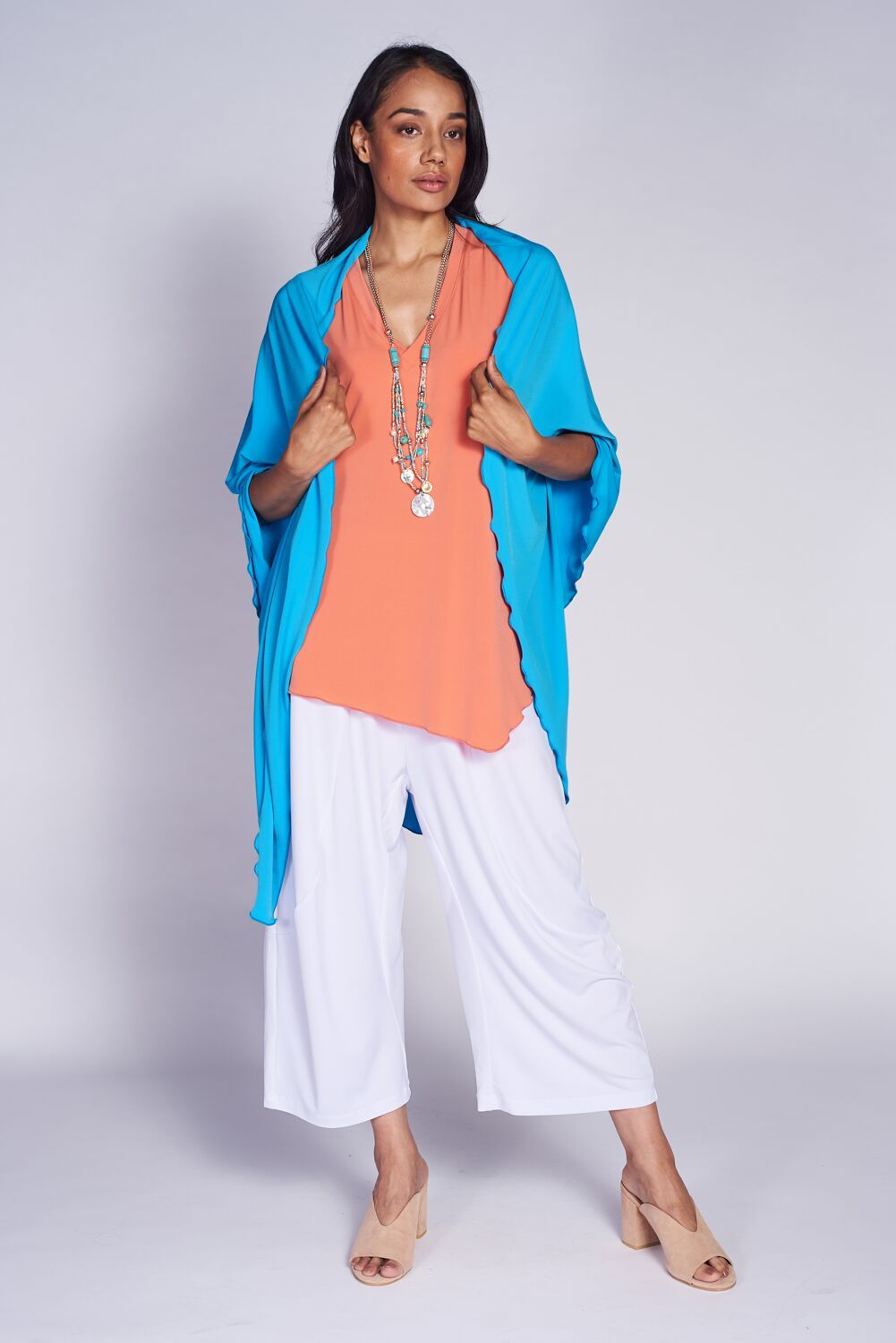 A stylish Point Shawl made from 94% polyester and 6% spandex, showcasing its elegant design and versatile colors.