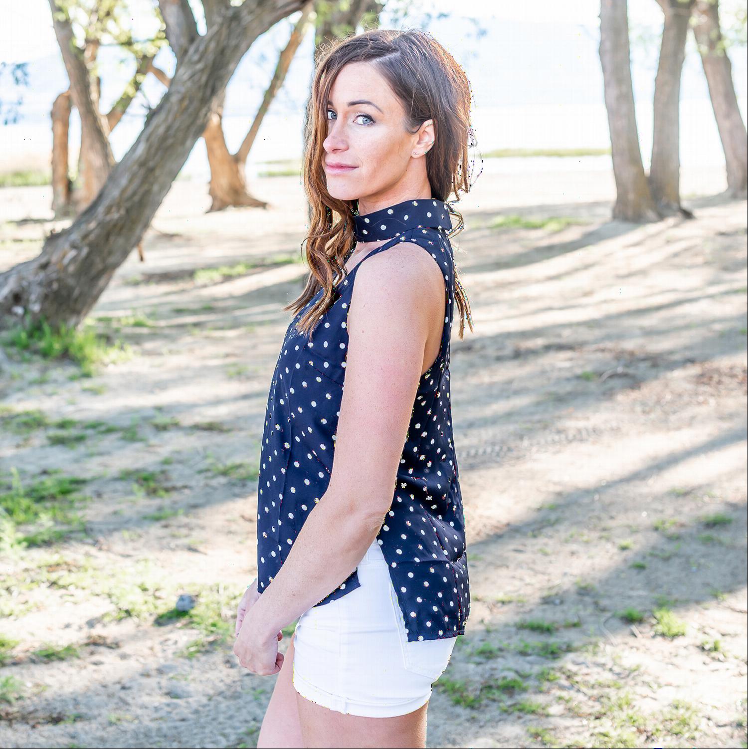 A stylish Polka Dot Mock Neck Sleeveless Blouse featuring a v-cut out design and side slits, perfect for versatile outfits.