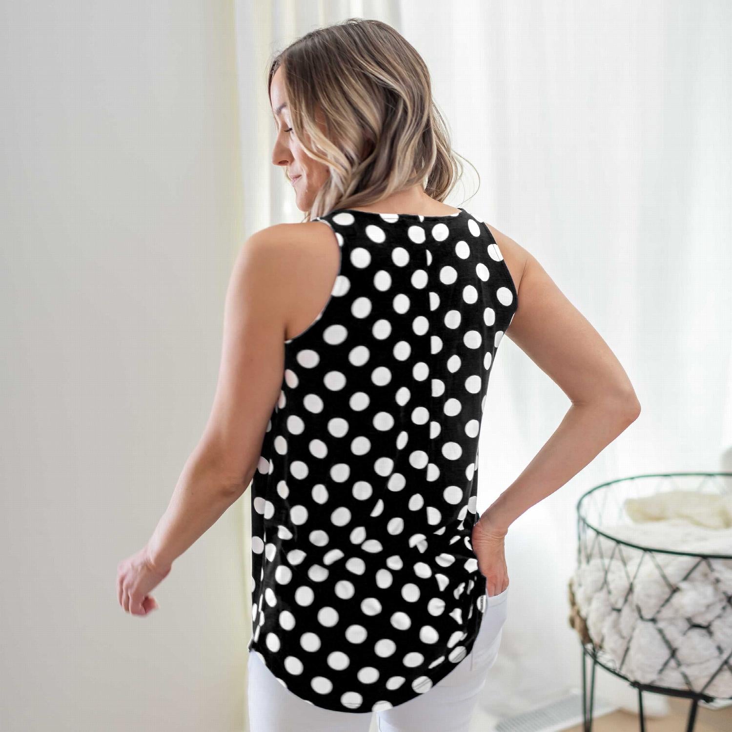 A stylish sleeveless top featuring a playful polka dot design, round neckline, and round hem, perfect for casual wear.