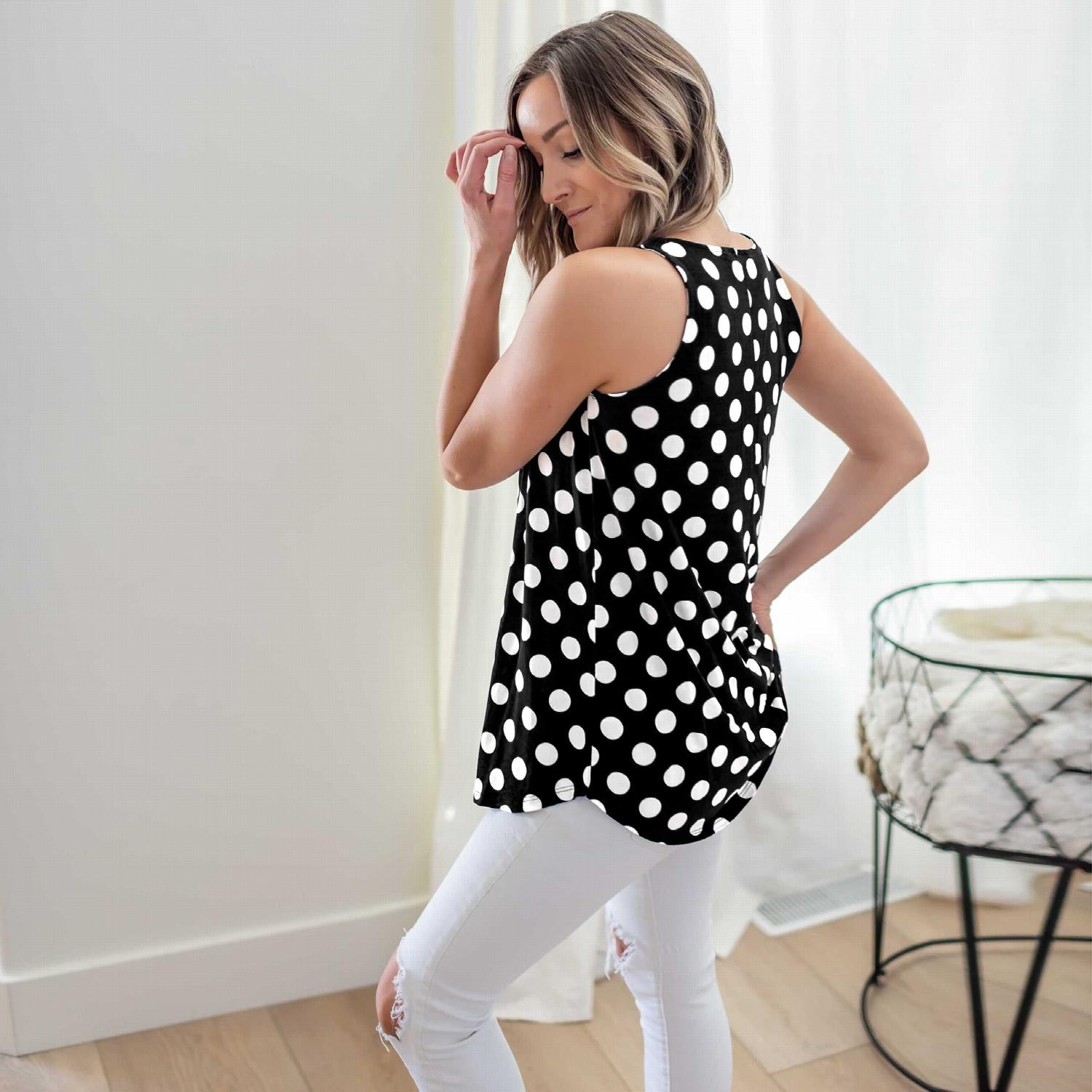 A stylish sleeveless top featuring a playful polka dot design, round neckline, and round hem, perfect for casual wear.