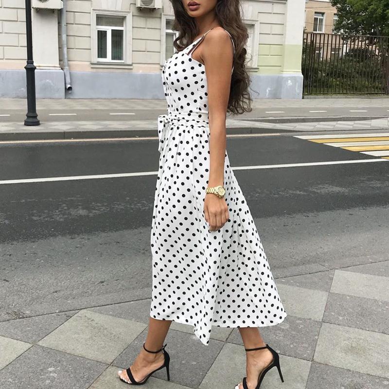 A stylish sleeveless polka dot women dress featuring a square collar and a belt, perfect for summer beach outings.