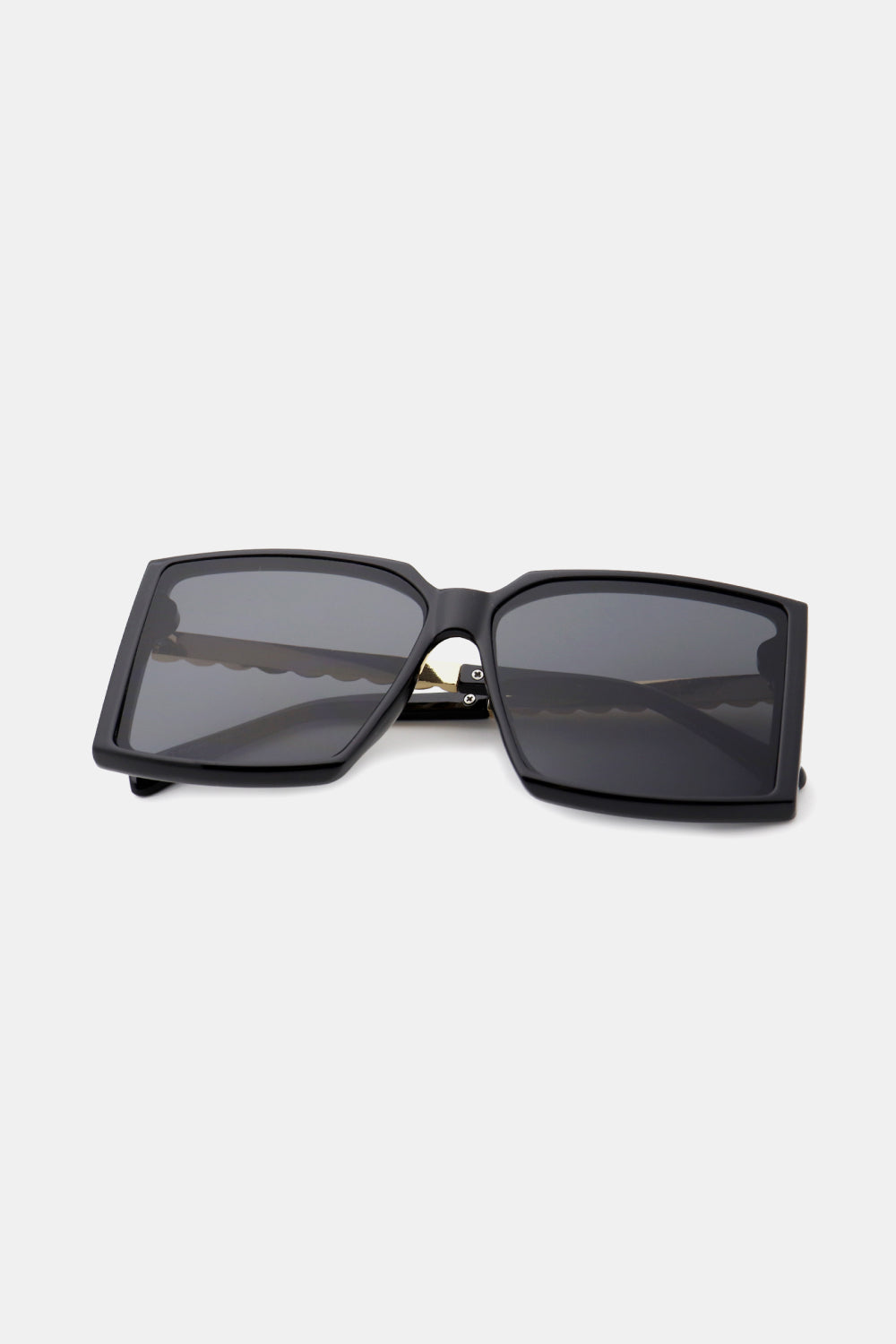 A pair of stylish square sunglasses with a polycarbonate frame and UV400 lenses, displayed in a protective case.