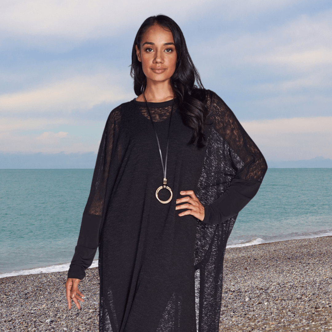 A stylish Poncho Dress made from textured mesh knit fabric, showcasing its versatile design and breathable material.