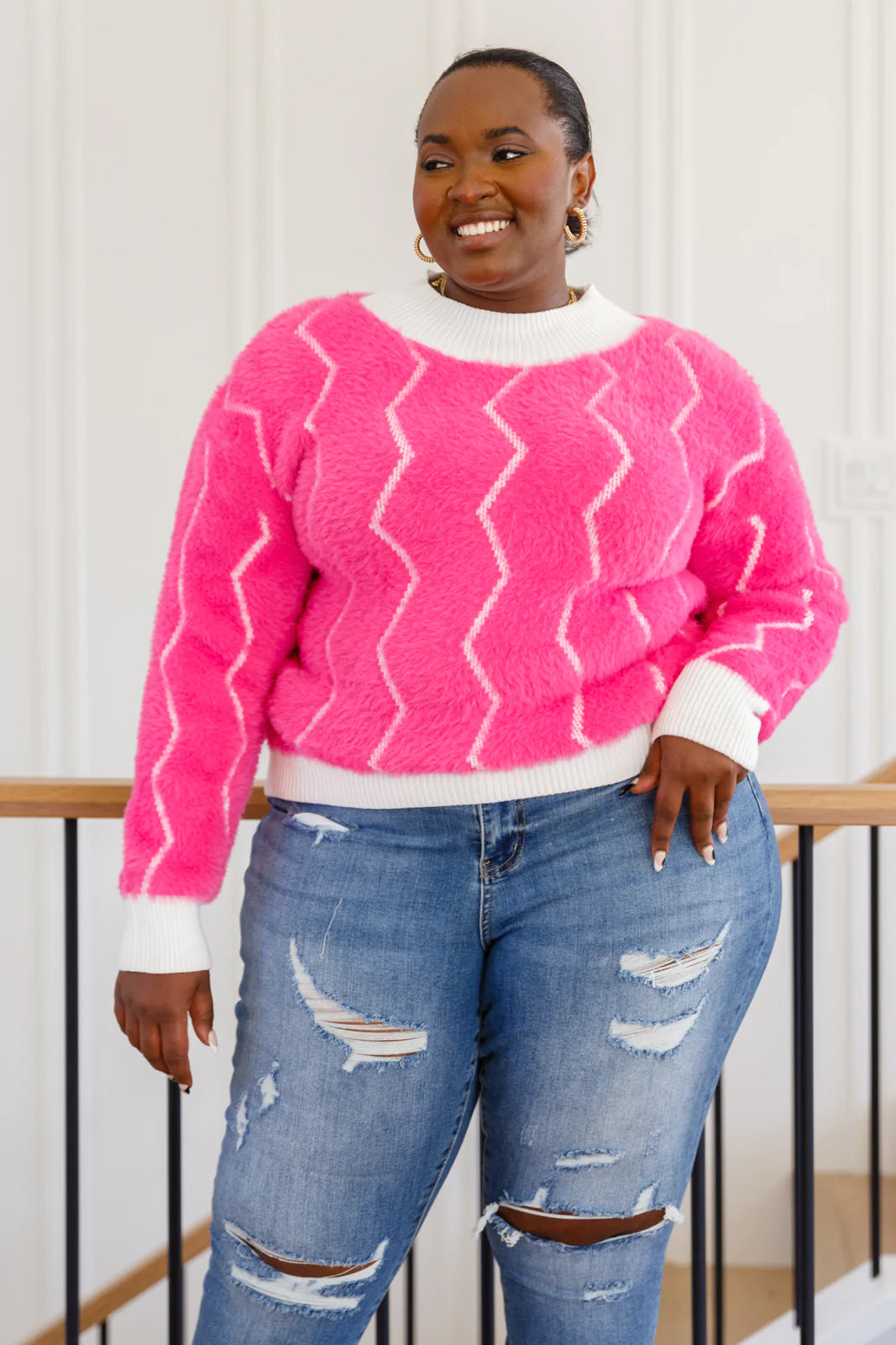 A vibrant pink Pop Culture Zig Zag Sweater featuring a stylish white collar and cuffs, perfect for fall fashion.