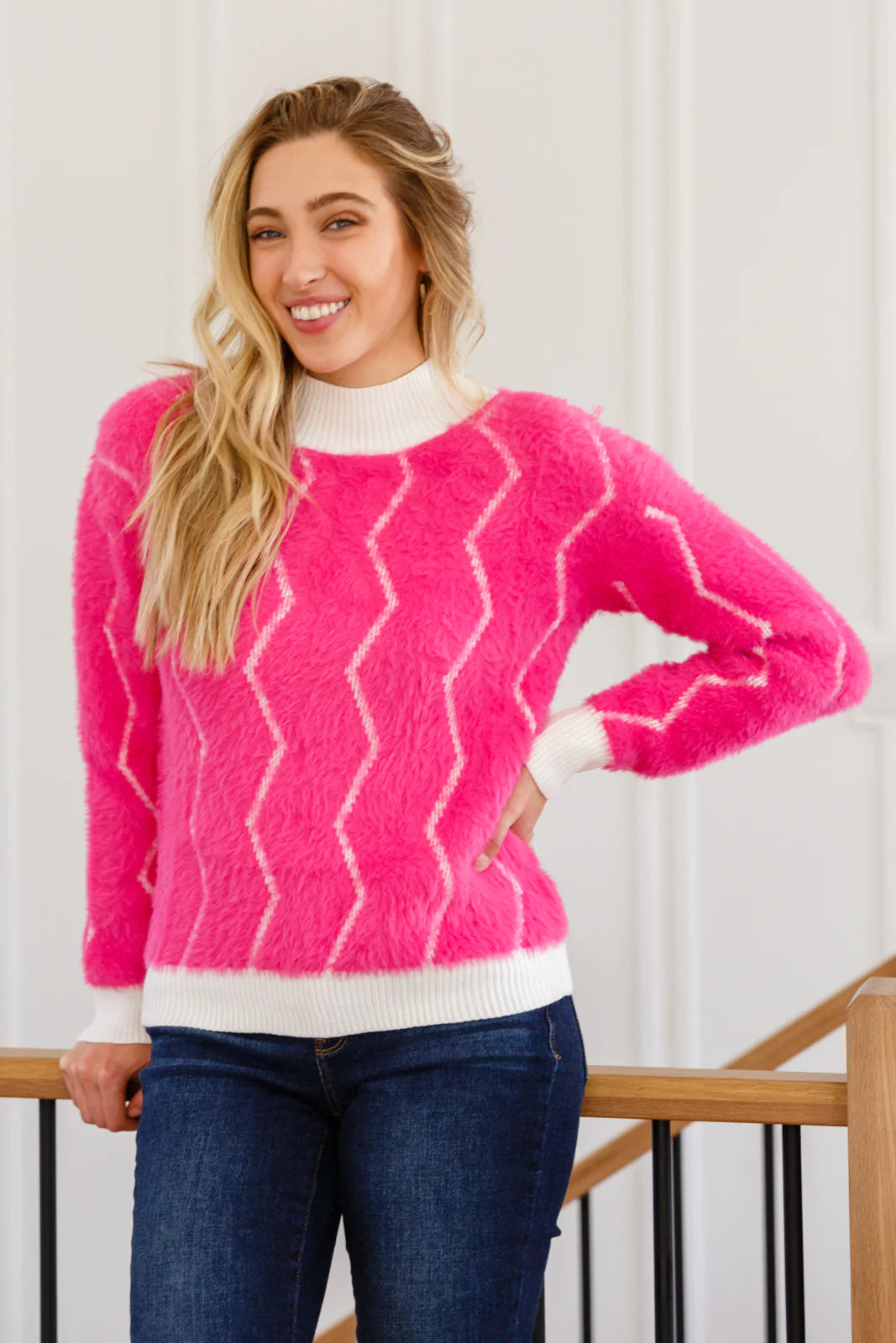 A vibrant pink Pop Culture Zig Zag Sweater featuring a stylish white collar and cuffs, perfect for fall fashion.