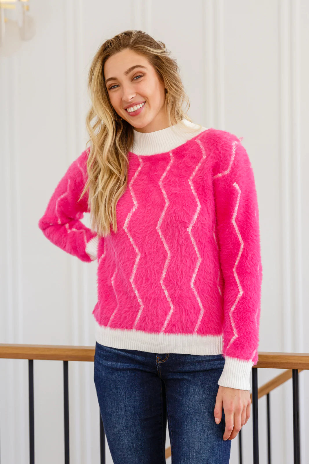 A vibrant pink Pop Culture Zig Zag Sweater featuring a stylish white collar and cuffs, perfect for fall fashion.