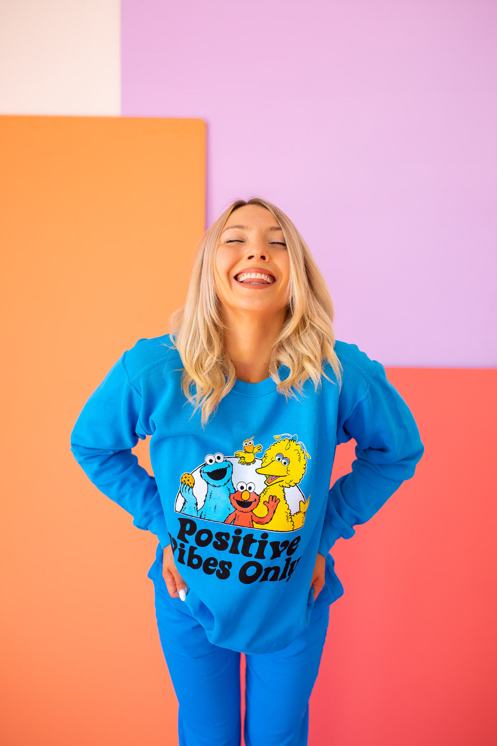 Positive Vibes Sesame Sweatshirt in blue featuring iconic Sesame Street characters, made from 100% upcycled cotton.