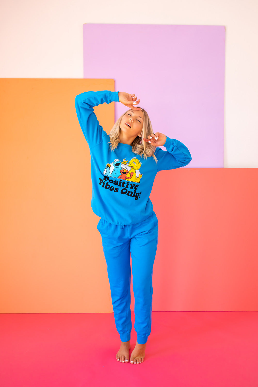 Positive Vibes Sesame Sweatshirt in blue featuring iconic Sesame Street characters, made from 100% upcycled cotton.