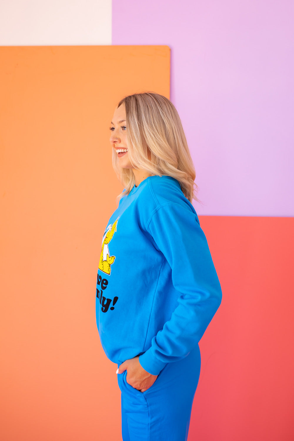 Positive Vibes Sesame Sweatshirt in blue featuring iconic Sesame Street characters, made from 100% upcycled cotton.