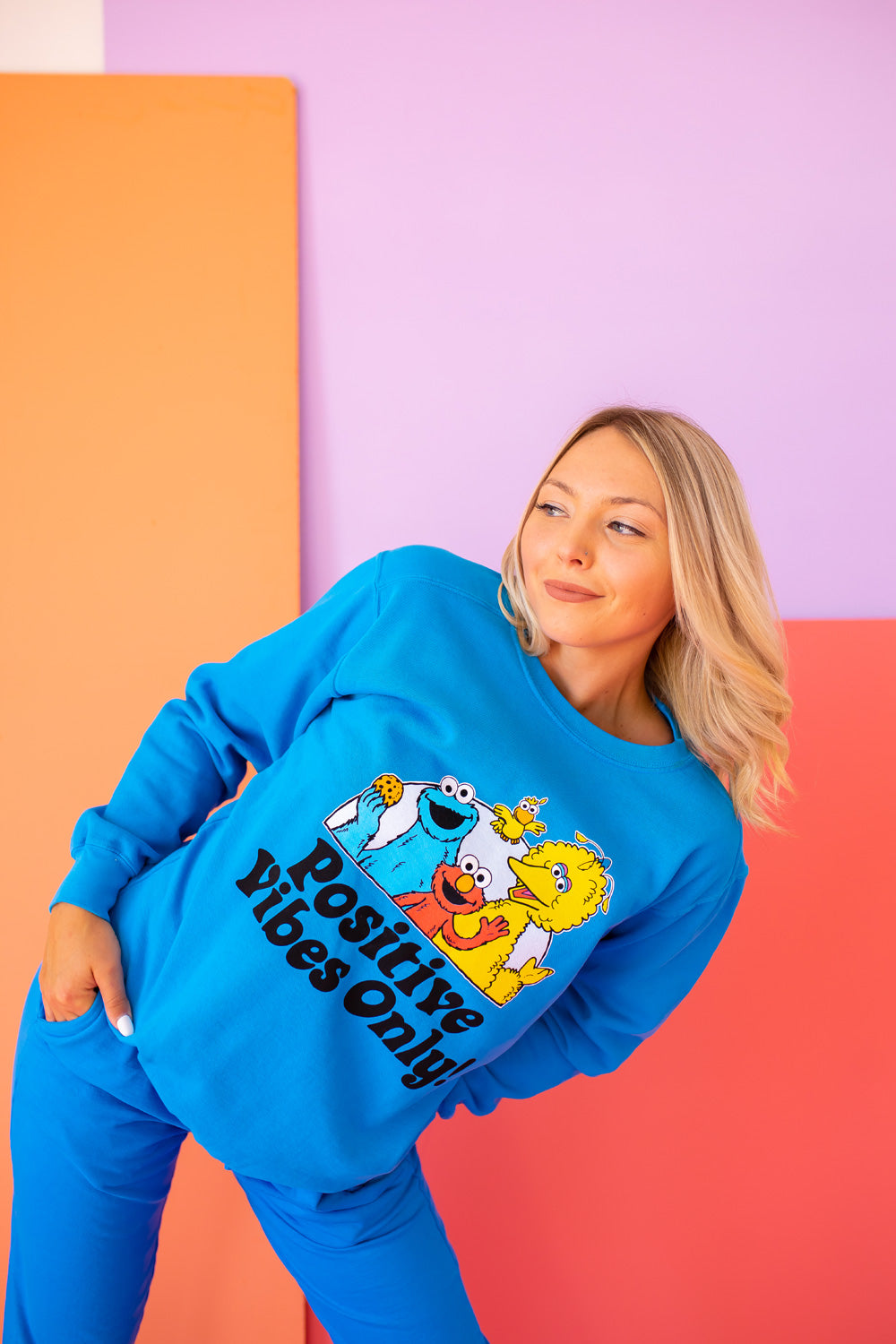 Positive Vibes Sesame Sweatshirt in blue featuring iconic Sesame Street characters, made from 100% upcycled cotton.