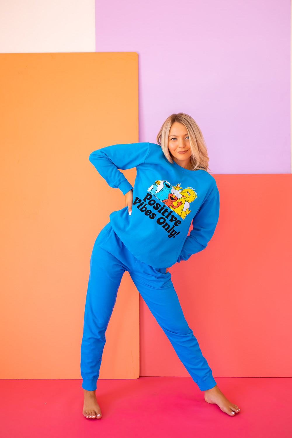 Positive Vibes Sesame Sweatshirt in blue featuring iconic Sesame Street characters, made from 100% upcycled cotton.