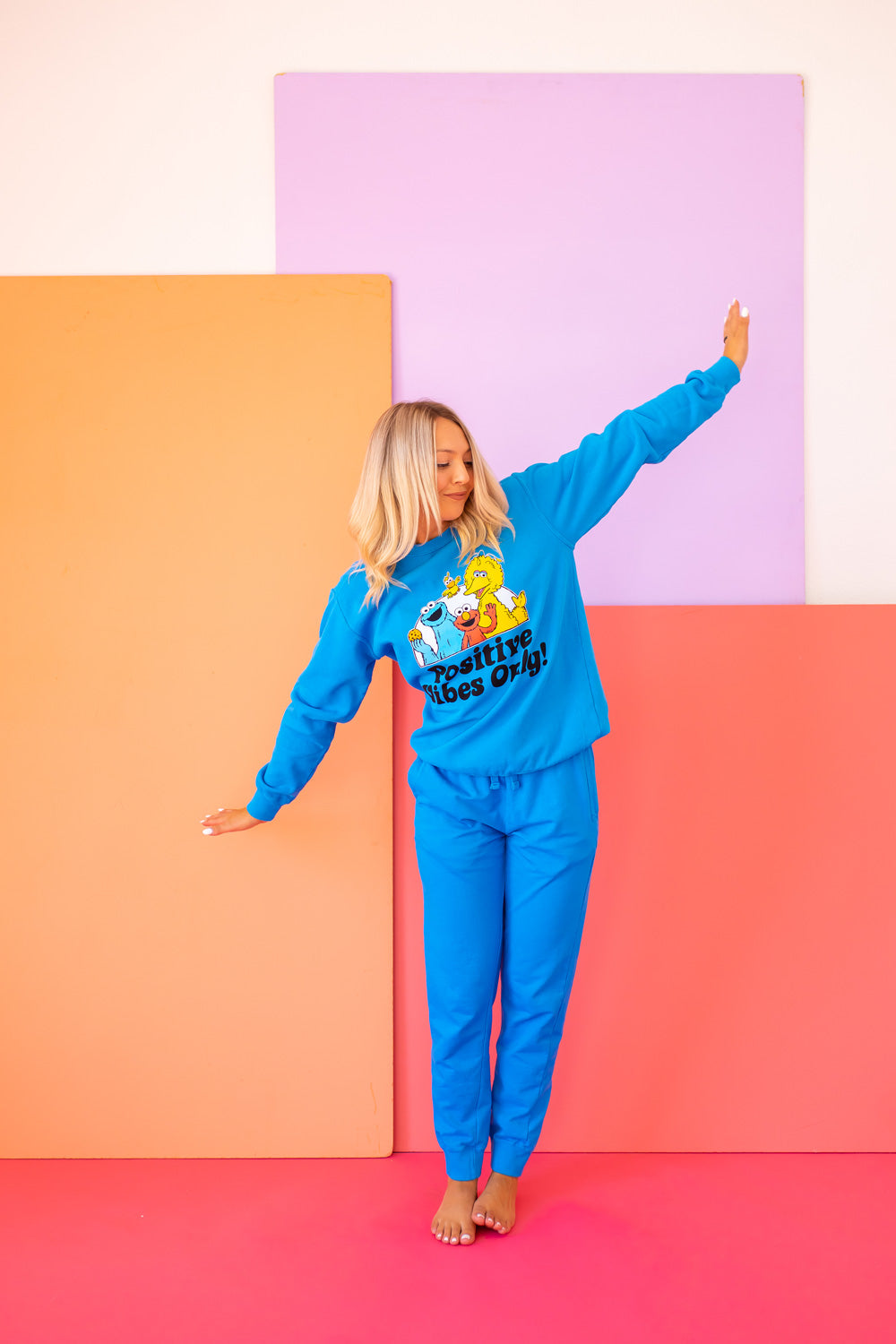 Positive Vibes Sesame Sweatshirt in blue featuring iconic Sesame Street characters, made from 100% upcycled cotton.