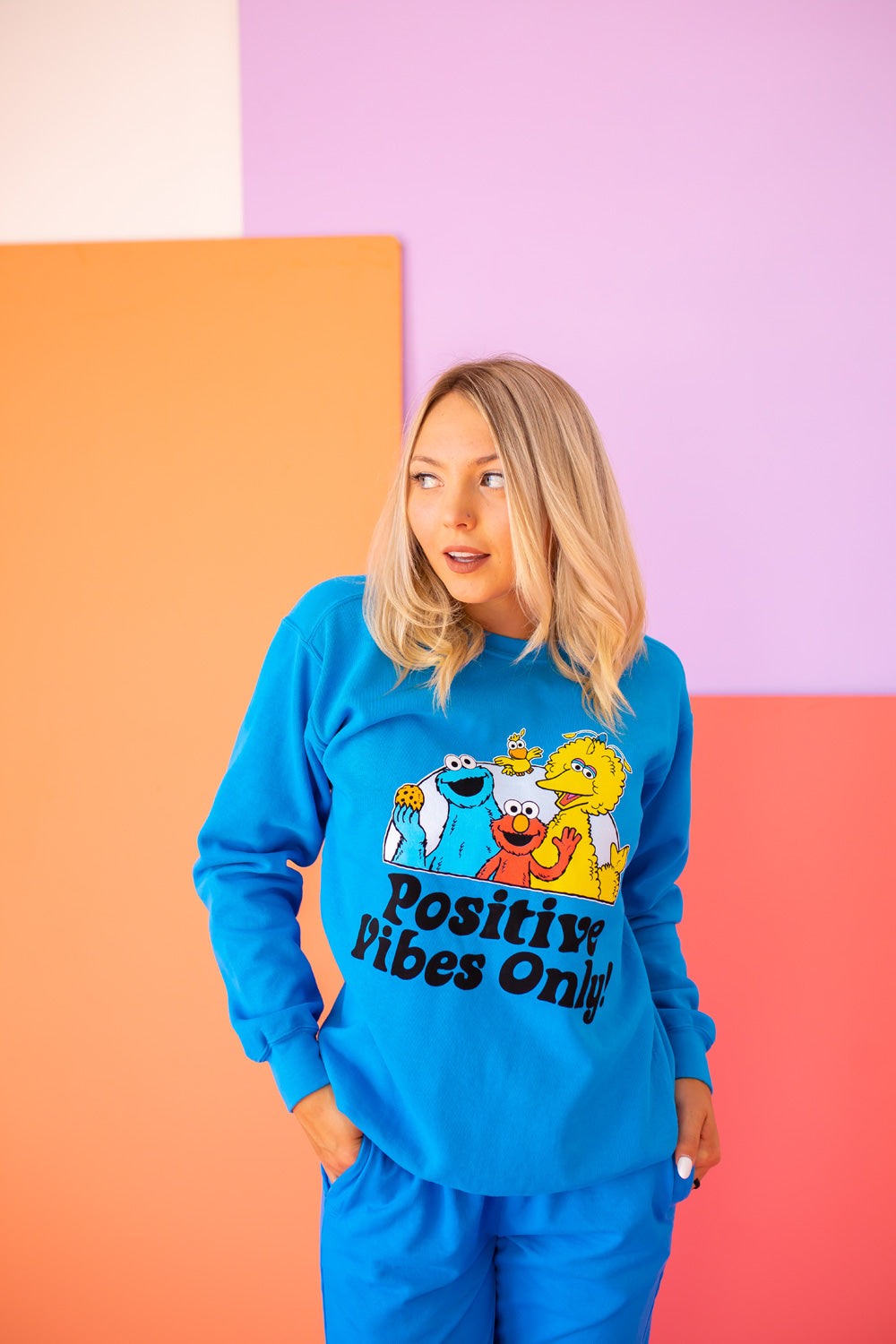 Positive Vibes Sesame Sweatshirt in blue featuring iconic Sesame Street characters, made from 100% upcycled cotton.