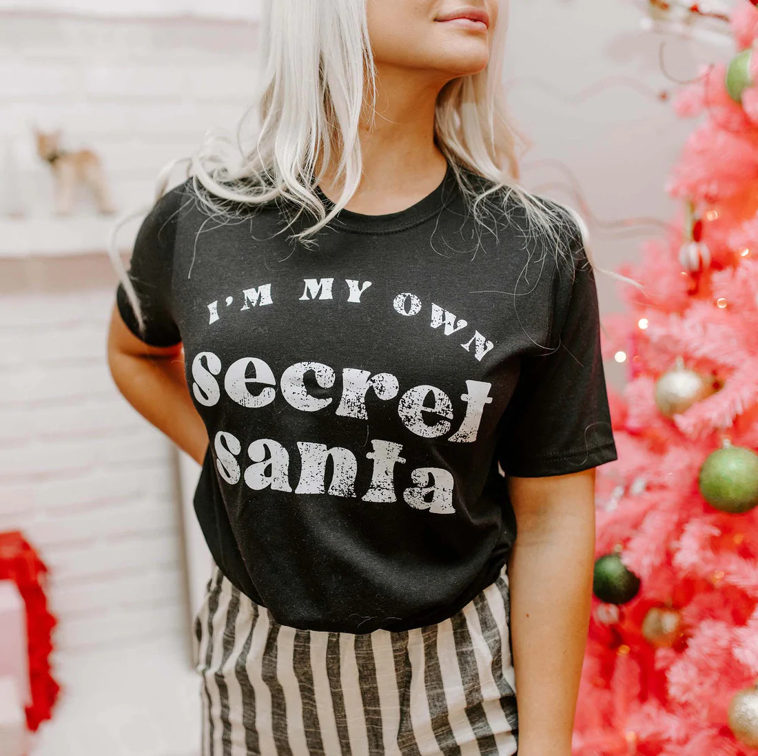 Black unisex t-shirt featuring the phrase 'I'm My Own Secret Santa' in festive lettering, perfect for holiday celebrations.