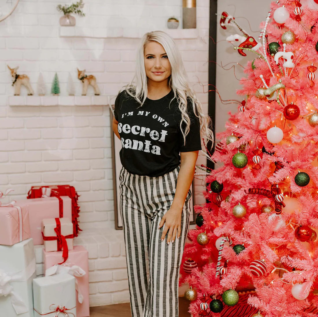 Black unisex t-shirt featuring the phrase 'I'm My Own Secret Santa' in festive lettering, perfect for holiday celebrations.