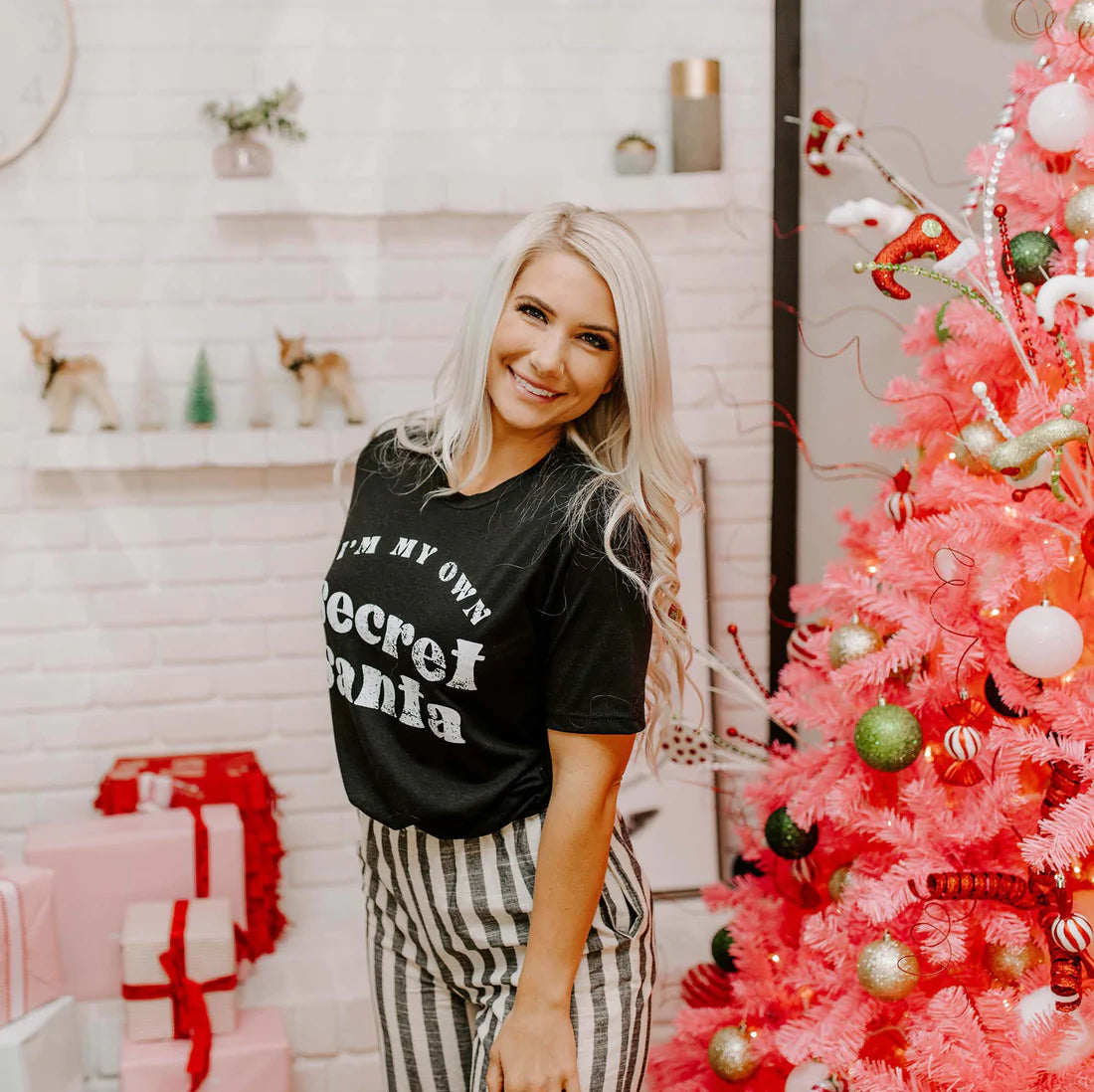 Black unisex t-shirt featuring the phrase 'I'm My Own Secret Santa' in festive lettering, perfect for holiday celebrations.