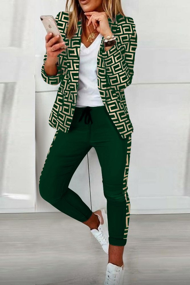 Nunzia dark green print blazer and pants set featuring geometric patterns, long sleeves, and a classic collar.