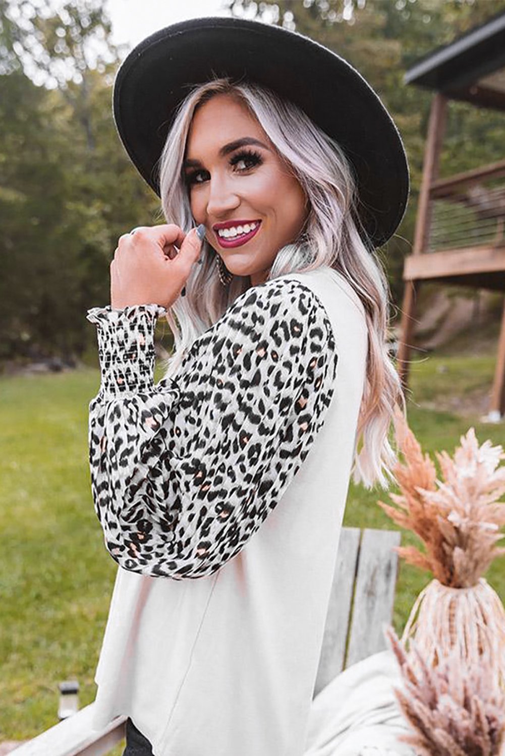 A stylish Print Crew Neck Puff Sleeve Top featuring a bold leopard print pattern in black and light neutral tones, with smocked cuffs and a keyhole back.