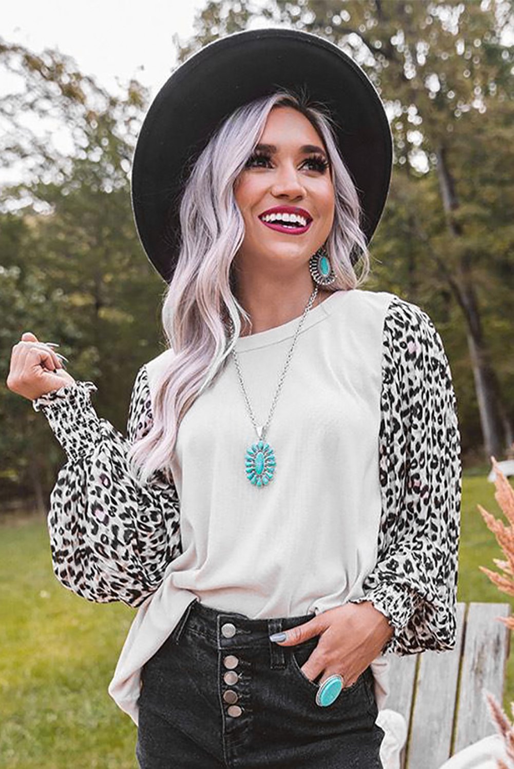 A stylish Print Crew Neck Puff Sleeve Top featuring a bold leopard print pattern in black and light neutral tones, with smocked cuffs and a keyhole back.