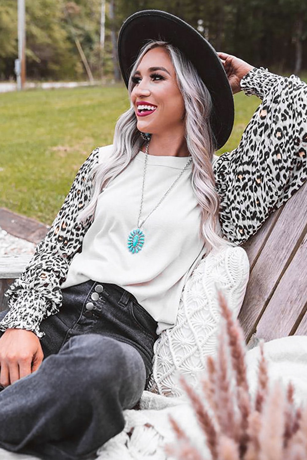 A stylish Print Crew Neck Puff Sleeve Top featuring a bold leopard print pattern in black and light neutral tones, with smocked cuffs and a keyhole back.