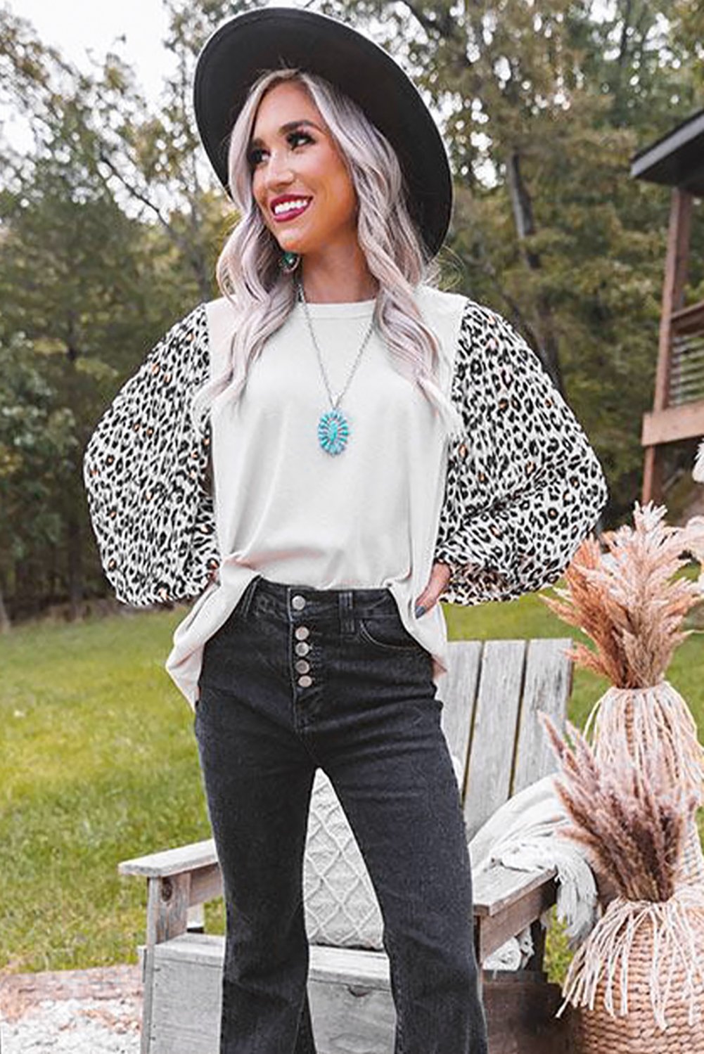 A stylish Print Crew Neck Puff Sleeve Top featuring a bold leopard print pattern in black and light neutral tones, with smocked cuffs and a keyhole back.