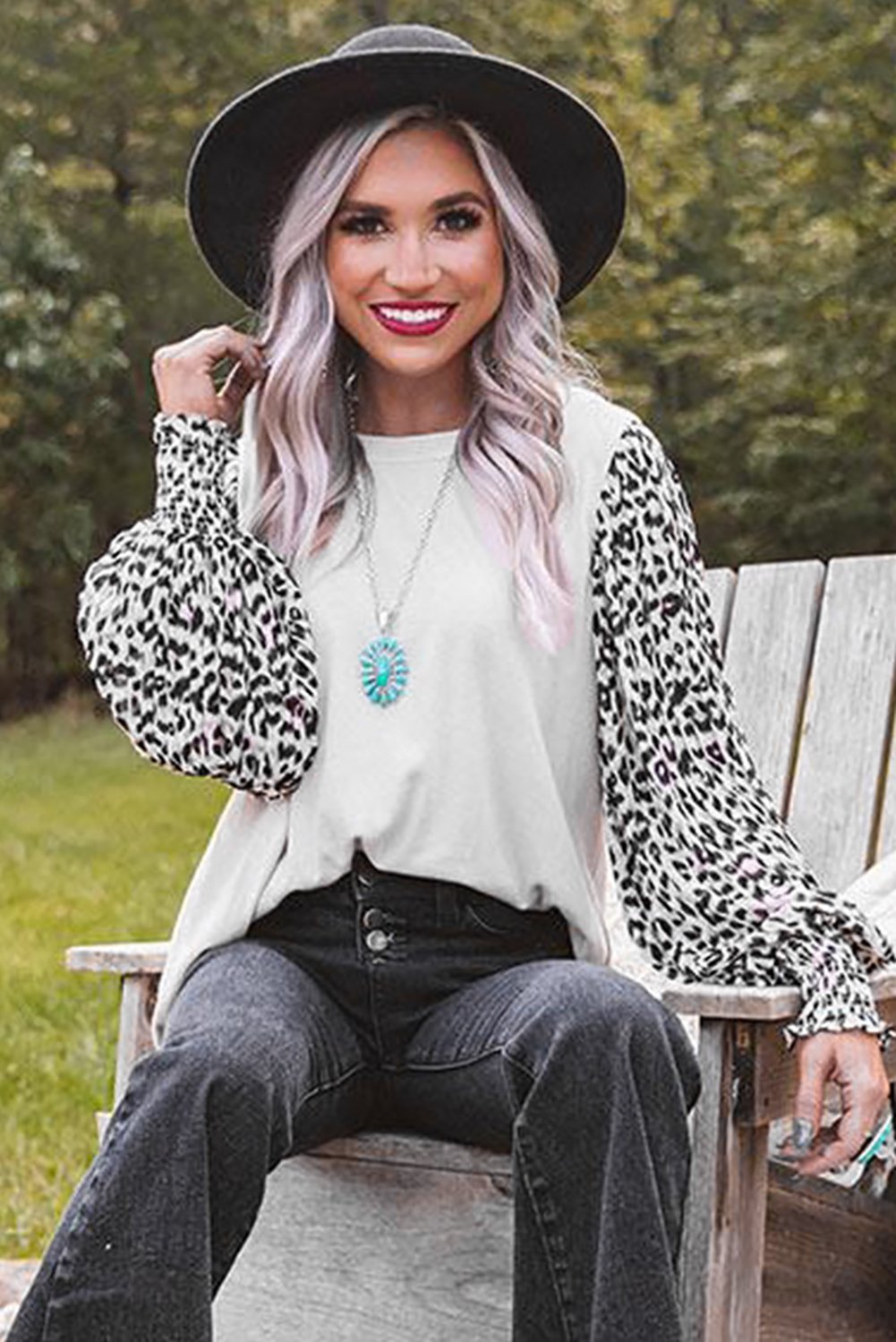 A stylish Print Crew Neck Puff Sleeve Top featuring a bold leopard print pattern in black and light neutral tones, with smocked cuffs and a keyhole back.