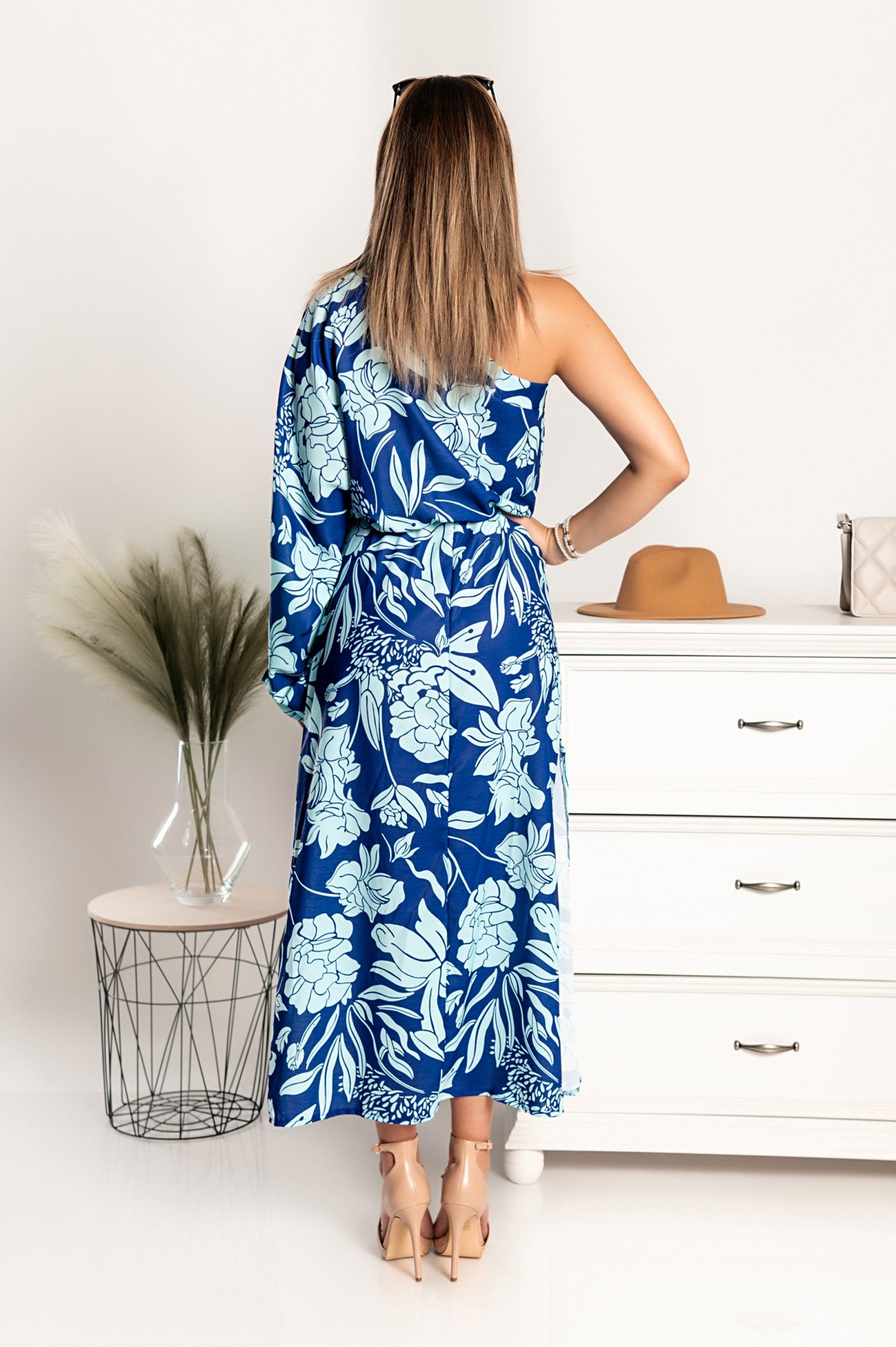 Elegant blue maxi dress with asymmetrical neckline and one sleeve, featuring an elastic waist and skirt opening, made in Italy.