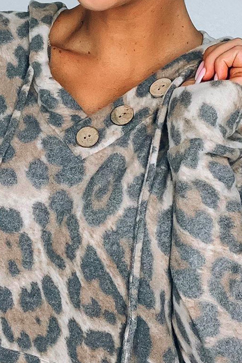 A stylish Print Kangaroo Pocket Hoodie featuring a chic animal print, drawstring hood, and large kangaroo pouch pocket.