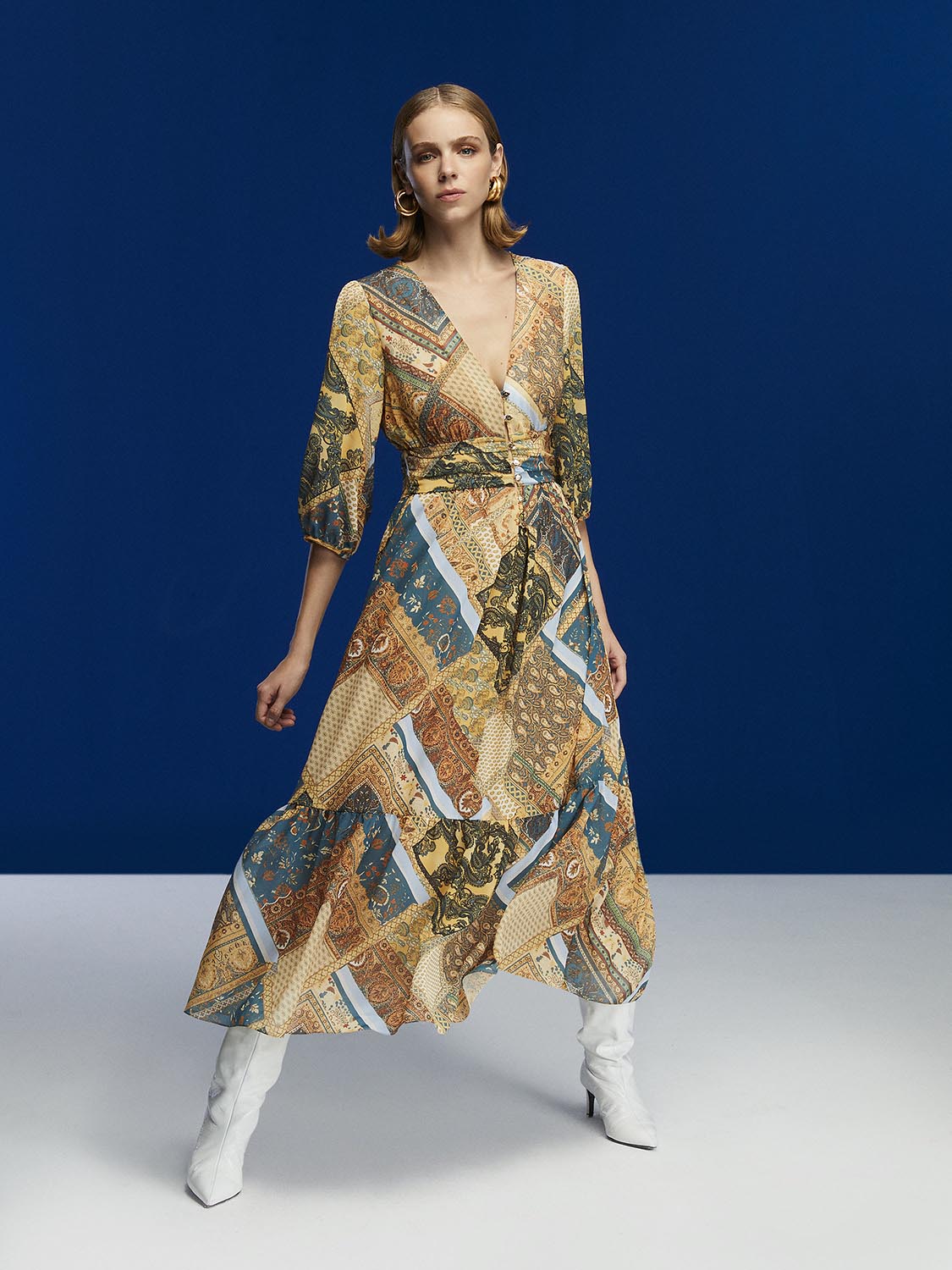 A flowy Print Midi Dress featuring a V-neck design and below-the-elbow sleeves, showcasing a vibrant print.