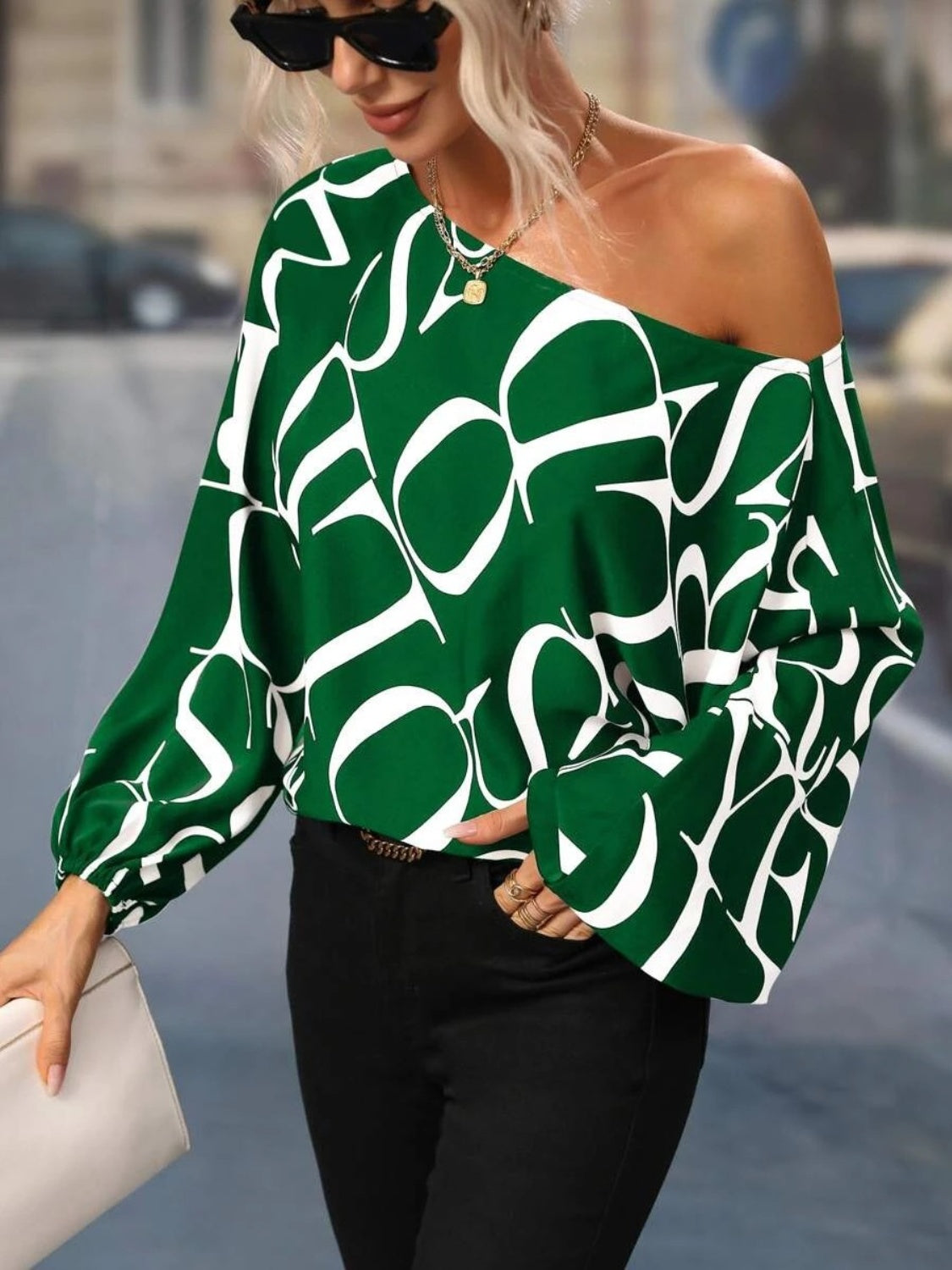 A stylish Printed Boat Neck Blouse in a vibrant print, showcasing its elegant boat neck design and lightweight fabric.