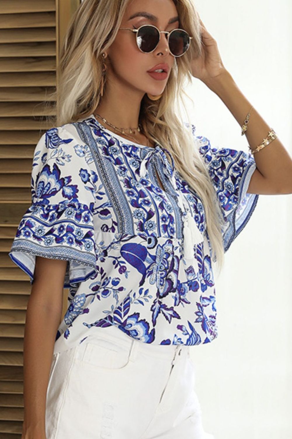 A stylish Printed Buttoned Flounce Sleeve Blouse featuring elegant flounce sleeves and a buttoned front, made from 100% polyester.