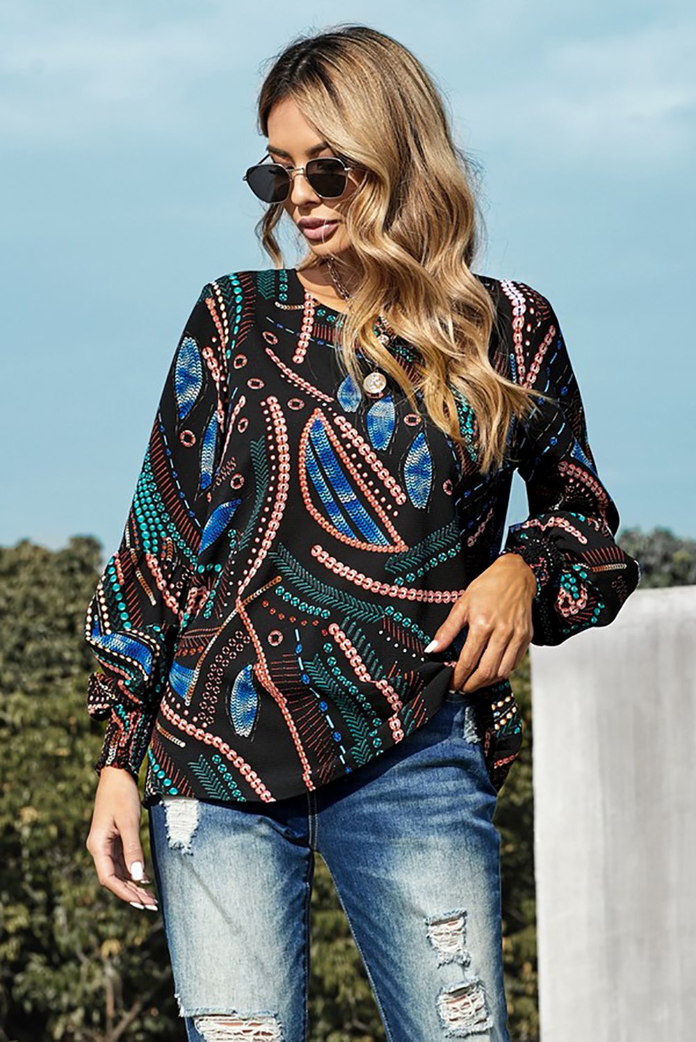 A stylish Printed Lantern Sleeve Top featuring balloon-shaped sleeves and an artistic curvilinear pattern in vibrant colors.