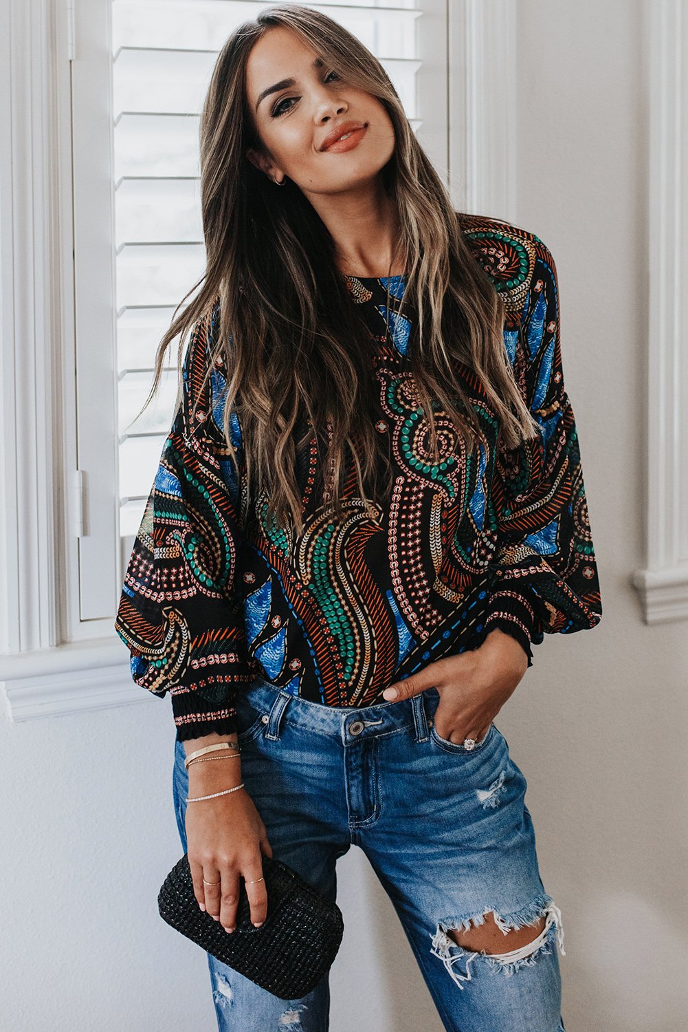 A stylish Printed Lantern Sleeve Top featuring balloon-shaped sleeves and an artistic curvilinear pattern in vibrant colors.