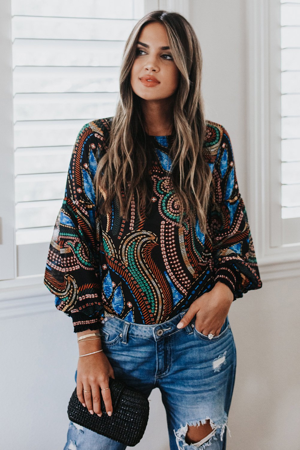 A stylish Printed Lantern Sleeve Top featuring balloon-shaped sleeves and an artistic curvilinear pattern in vibrant colors.