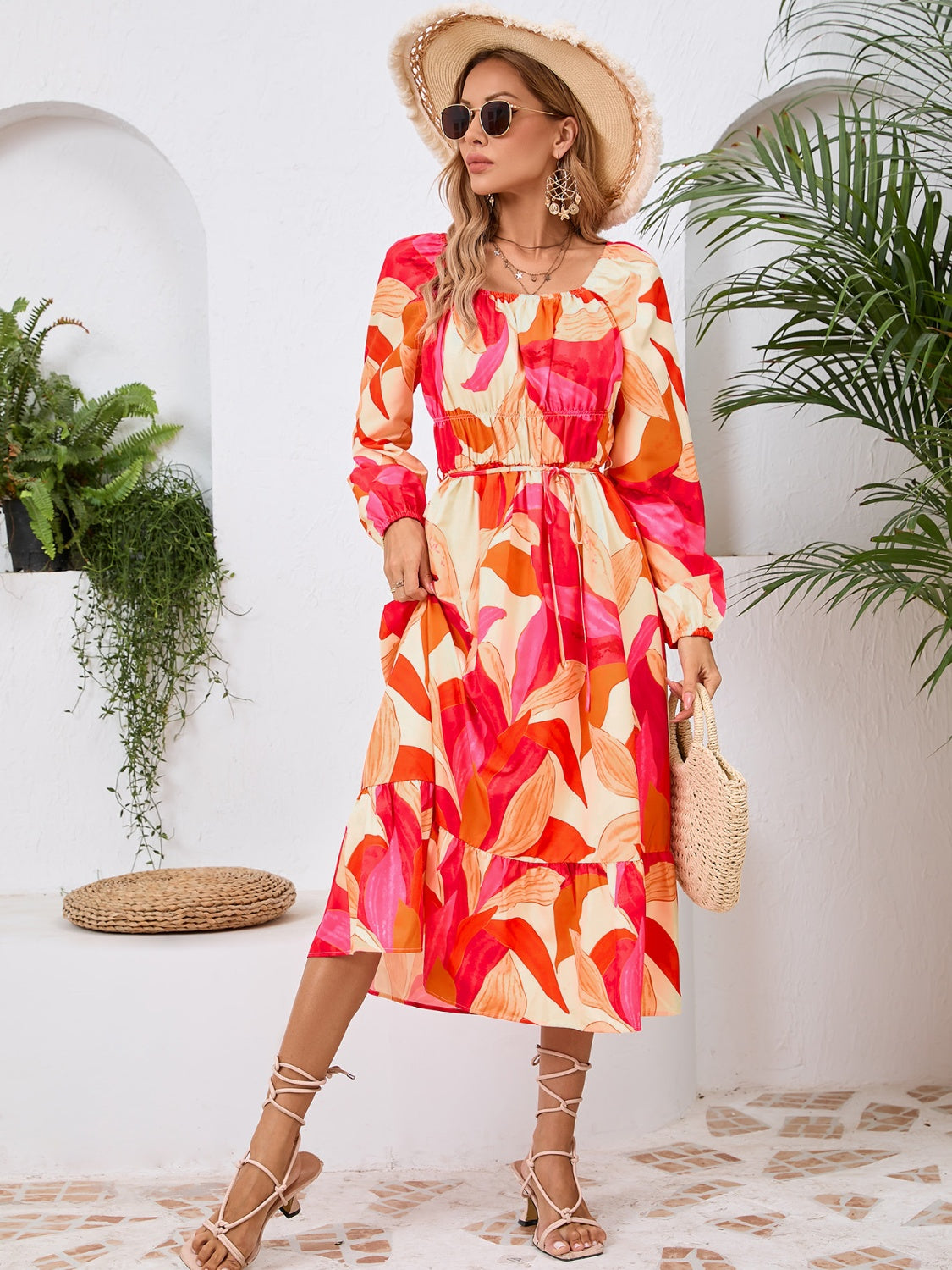 A stylish Printed Long Sleeve Midi Dress featuring a tied design, long sleeves, and a vibrant print, perfect for various occasions.