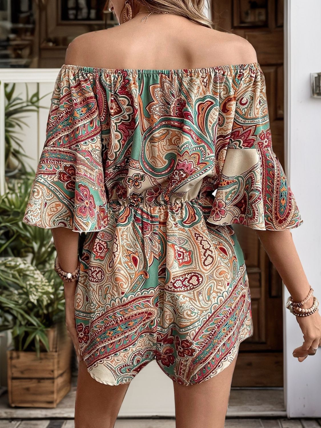 A stylish Printed Off Shoulder Half Sleeve Romper featuring ruffled details and a tied design, made from soft polyester fabric.