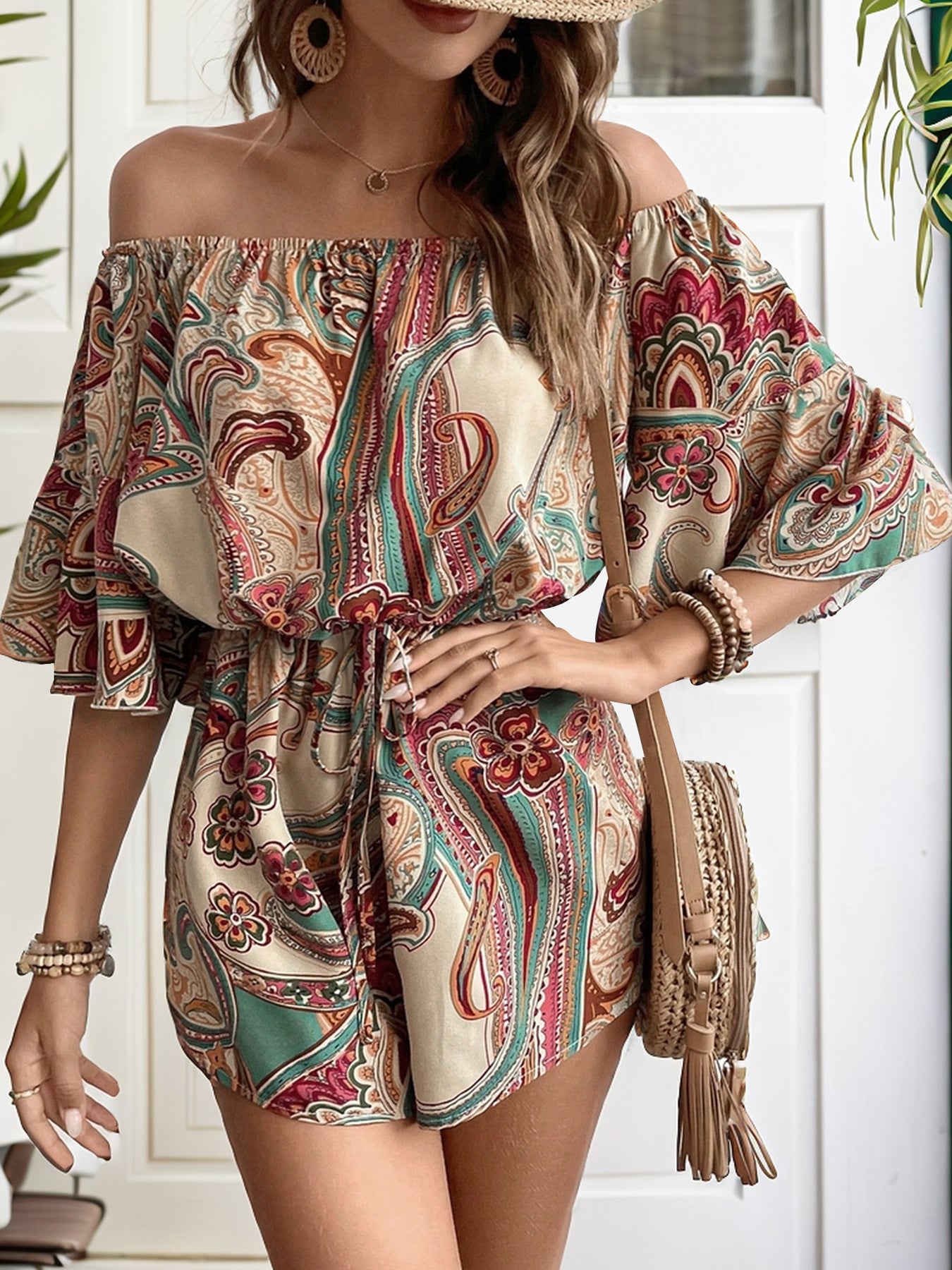 A stylish Printed Off Shoulder Half Sleeve Romper featuring ruffled details and a tied design, made from soft polyester fabric.