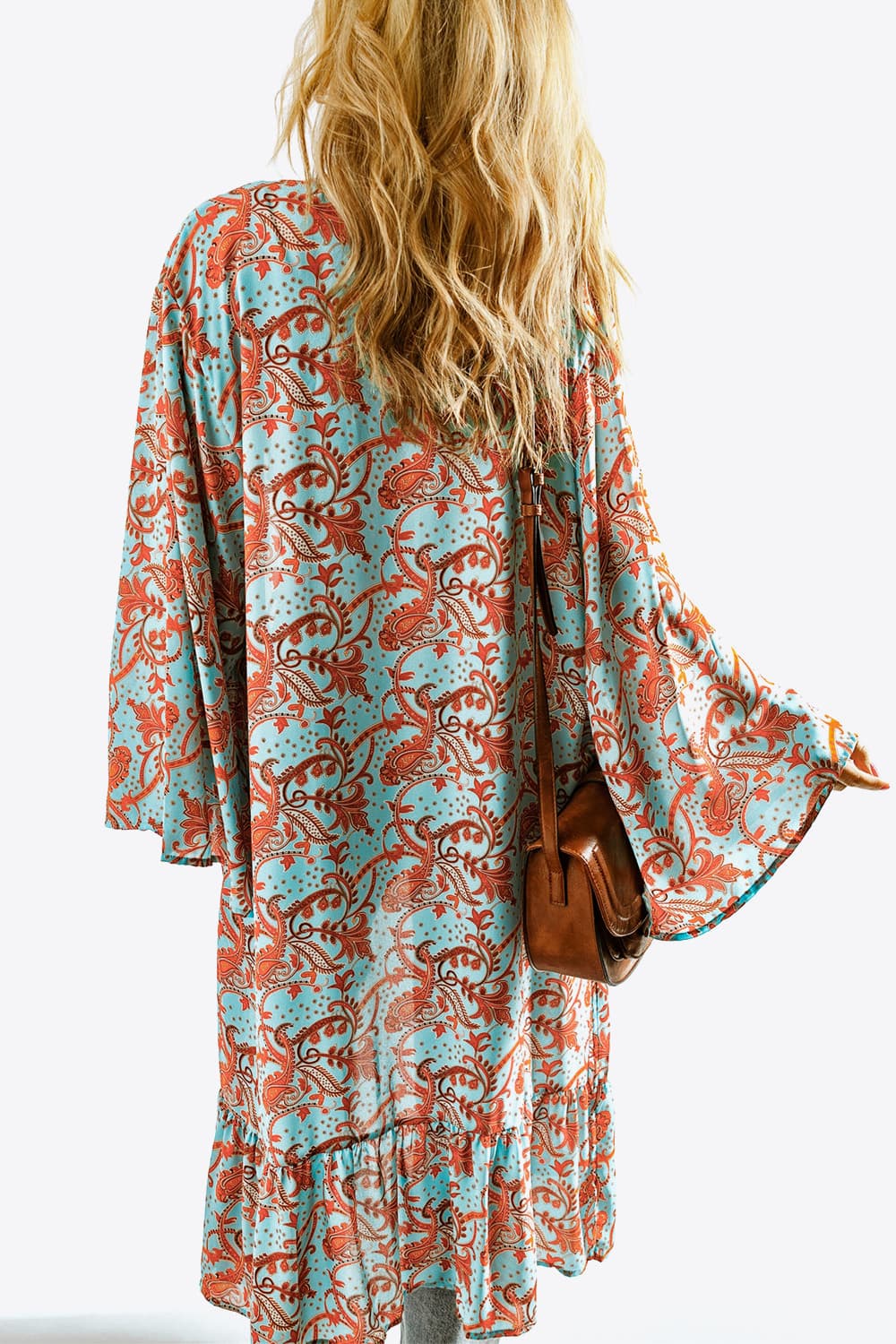 A stylish Printed Open Front Duster Cardigan featuring a floral pattern, ruffle details, and long flare sleeves, perfect for layering.