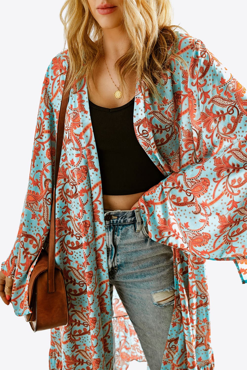 A stylish Printed Open Front Duster Cardigan featuring a floral pattern, ruffle details, and long flare sleeves, perfect for layering.