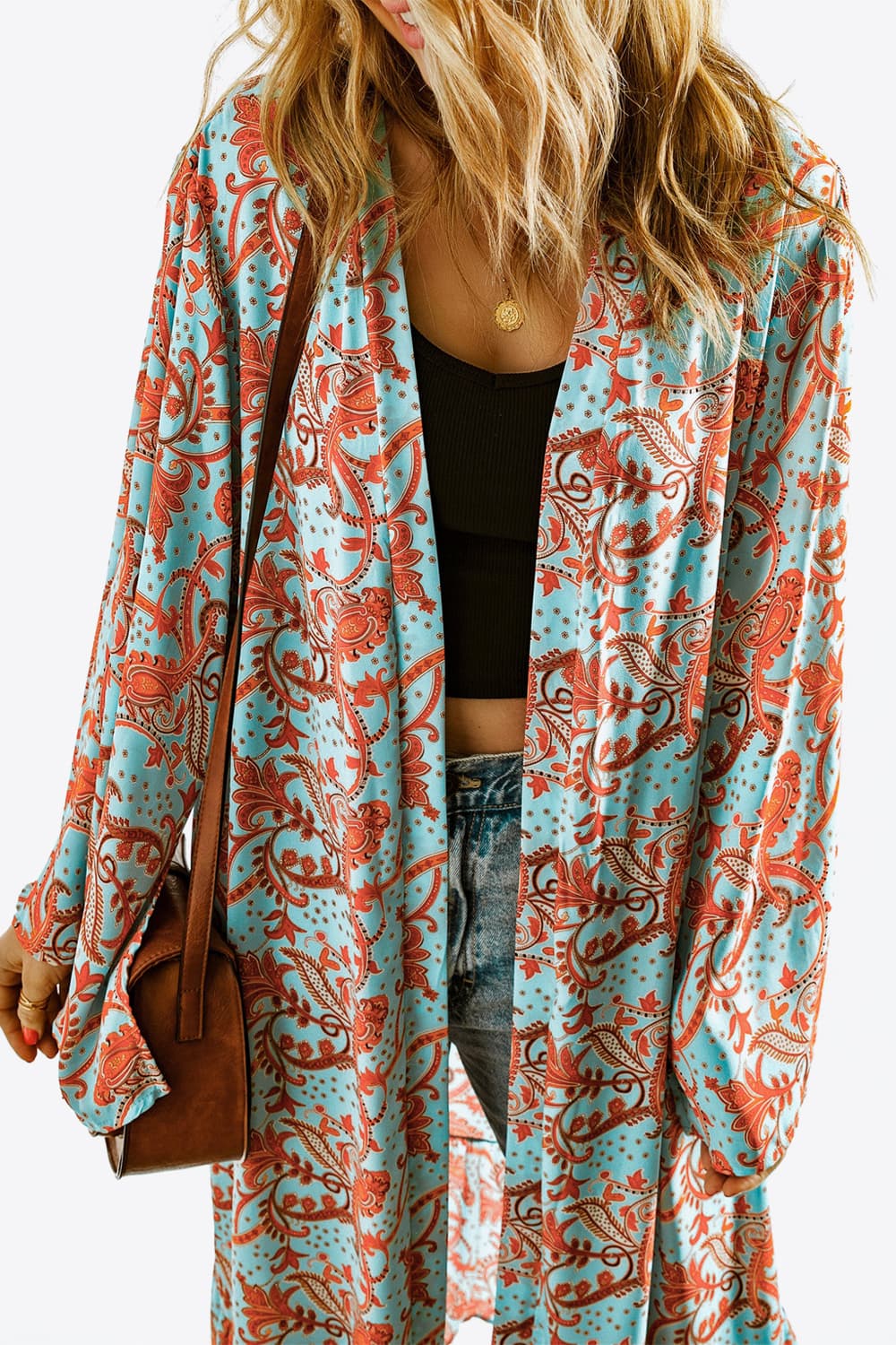 A stylish Printed Open Front Duster Cardigan featuring a floral pattern, ruffle details, and long flare sleeves, perfect for layering.