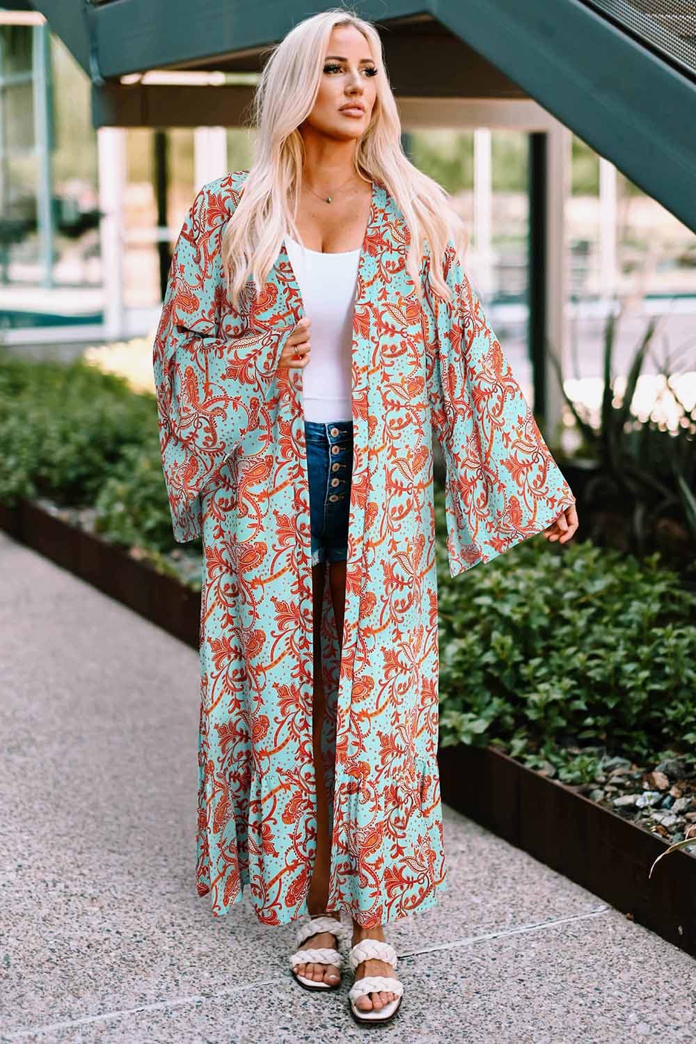 A stylish Printed Open Front Duster Cardigan featuring a floral pattern, ruffle details, and long flare sleeves, perfect for layering.