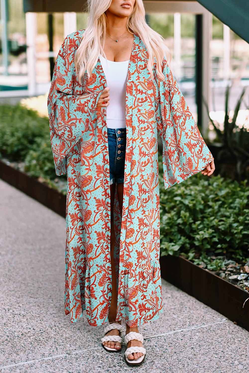 A stylish Printed Open Front Duster Cardigan featuring a floral pattern, ruffle details, and long flare sleeves, perfect for layering.