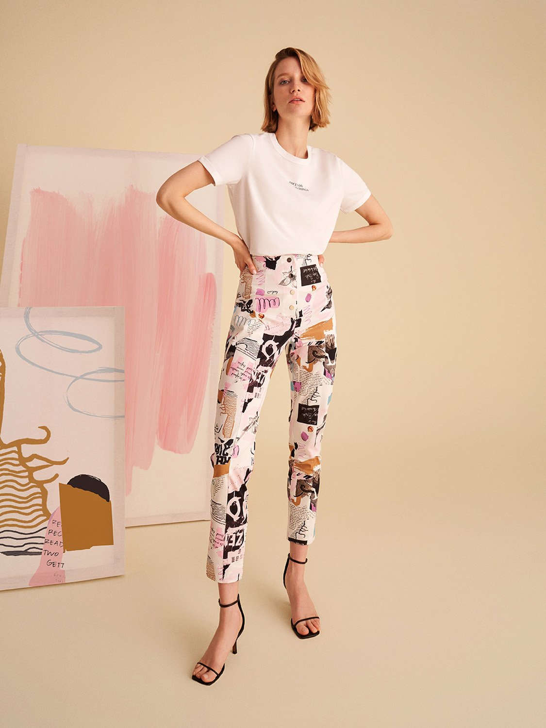 A stylish Printed Oversize T-shirt featuring vibrant digital collage patterns in hues of pink and white, showcasing a relaxed fit and crew neck design.